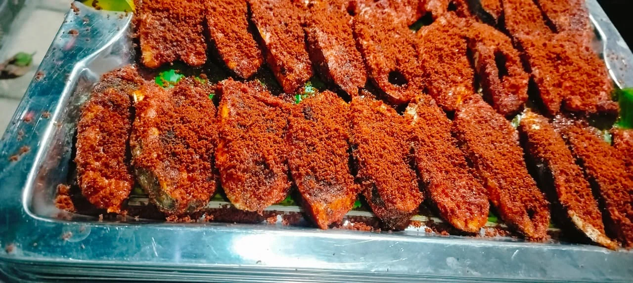 Marinated coastal-style food served on a banana leaf